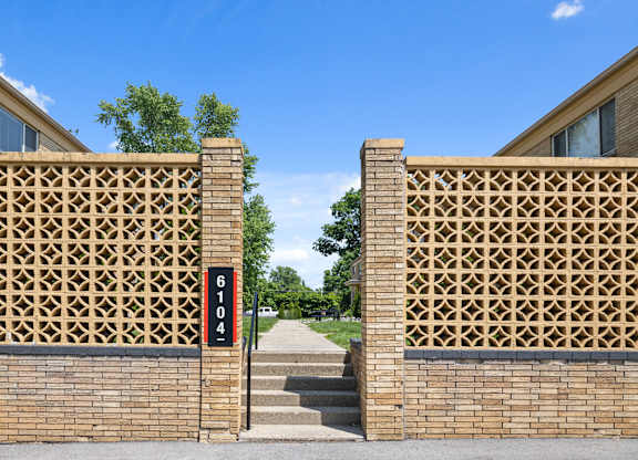 Mid-century modern entry wall and address marker at 6104 E 61st Street, entrance to Monon Court apartments in Broad Ripple