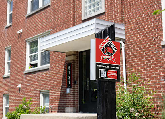 Close-up of leasing signage for Monon Court apartments at 6131 E 61st St, part of the Monon Living portfolio in Broad Ripple