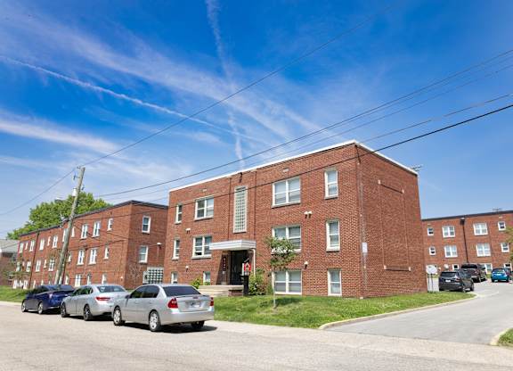 Street view of Monon Court’s red brick apartment buildings along Compton Street near E 61st in Broad Ripple, Indianapolis