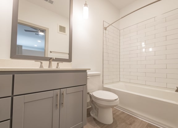 a bathroom with a toilet and a tub and a sink