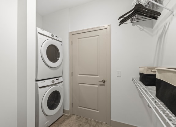 a washer and dryer in a laundry room with a white door