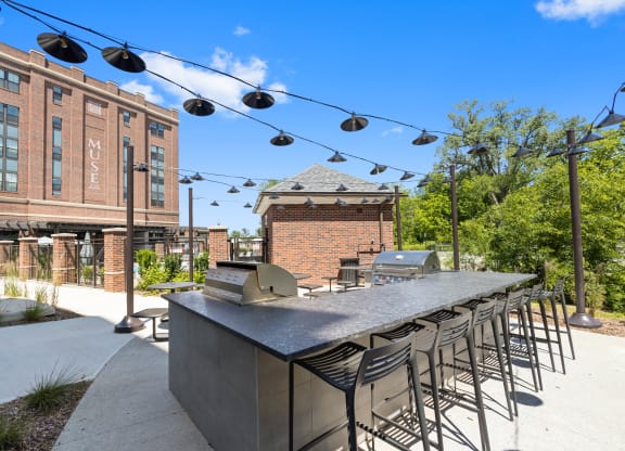 a communal bar with chairs and a building in the background