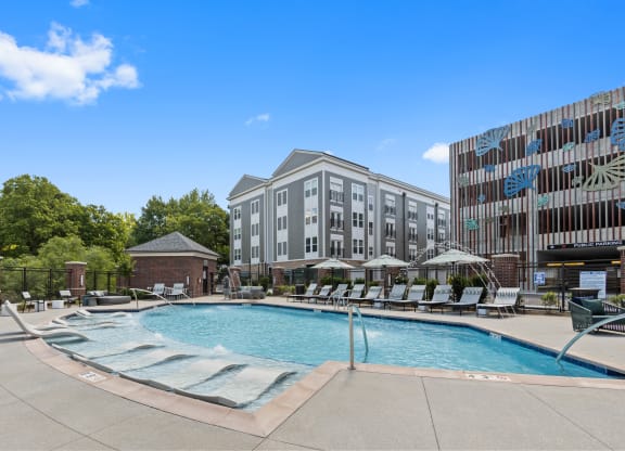 a swimming pool with a building in the background