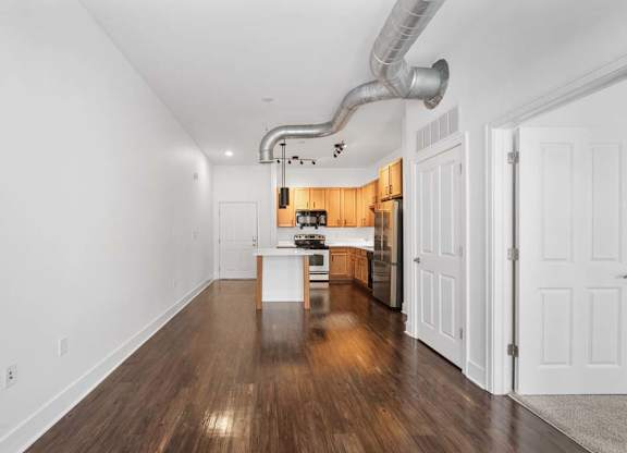 A long, narrow hallway with a kitchen area at The Foundry, South Bend, IN
