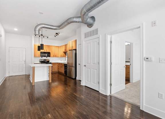 A kitchen with white walls and a wooden floor.at The Foundry, South Bend, 46617