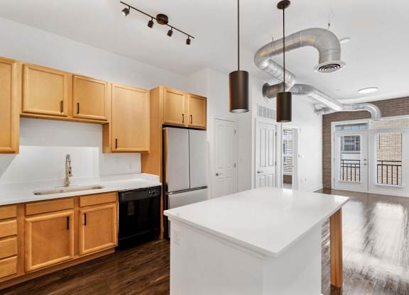 A kitchen with wooden cabinets and a white countertop.at The Foundry, South Bend, 46617