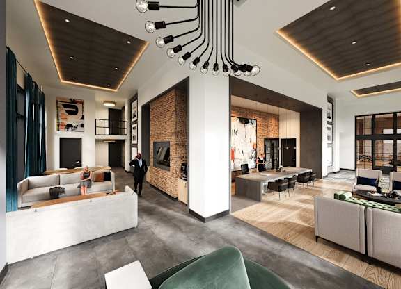 Modern leasing office at Contrast OTR in Cincinnati, Ohio, showcasing high ceilings, contemporary design elements, industrial-inspired lighting, and comfortable seating areas for residents and guests