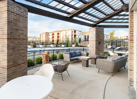 a patio with furniture and a pool at aria on the strip apartments at Echo Park at Perry Crossing Apartments, Plainfield, IN