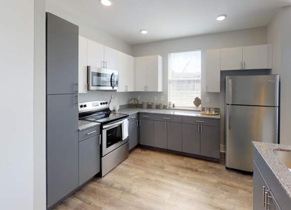 a kitchen with stainless steel appliances and white cabinets at Echo Park at Perry Crossing Apartments, Indiana, 46168