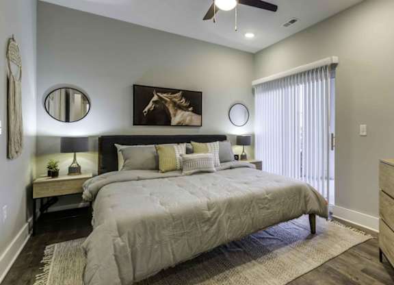 bedroom with bed and night stands with large window at Echo Park at Perry Crossing Apartments, Plainfield