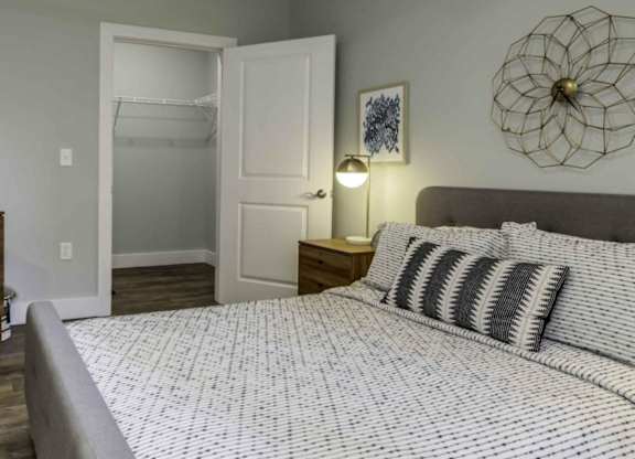 a bedroom with a bed and a closet at Echo Park at Perry Crossing Apartments, Plainfield, IN, 46168