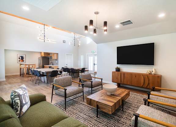 a living room and dining room with a large tv on the wall at THE ARLO, Citrus Heights, 95621