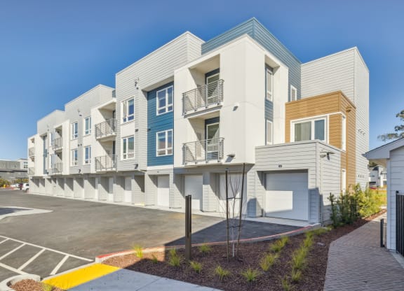 a row of modern apartments with balconies and a parking lot at 38° NORTH, Santa Rosa, CA