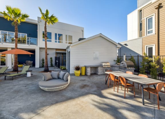 a patio with a table and chairs and a couch in front of a house at 38° NORTH, Santa Rosa, 95404