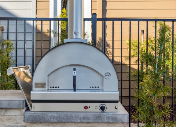 a silver domed oven sitting on a curb in front of a house at 38° NORTH, California, 95404