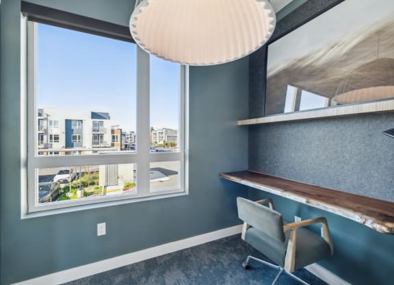 a desk and chair in a room with a window at 38° NORTH, California