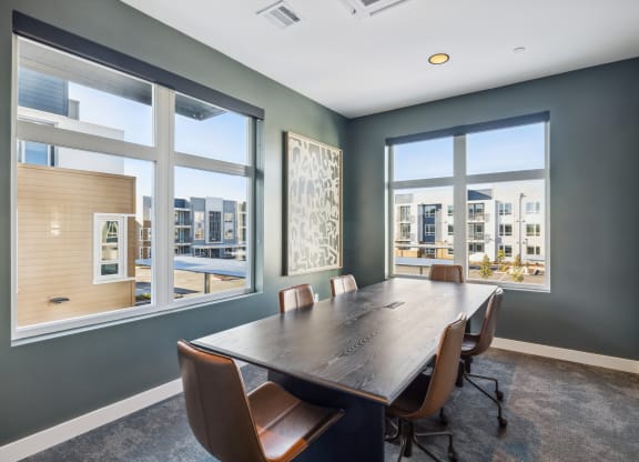 a conference room with a large window and a wooden table and chairs at 38° NORTH, Santa Rosa