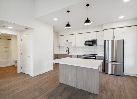 a renovated kitchen with white cabinets and stainless steel appliances at 38° NORTH, California, 95404
