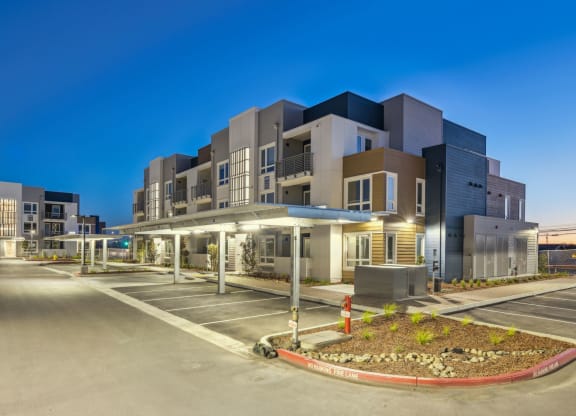 a building with a parking lot in front of it at night at 38° NORTH, Santa Rosa