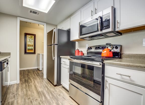 Kitchen with appliances and view to hall at BELLA VISTA AT HILLTOP, Richmond, California