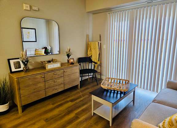A room with a wooden dresser, mirror, and a chair at Everett Senior Community, Everett, WA