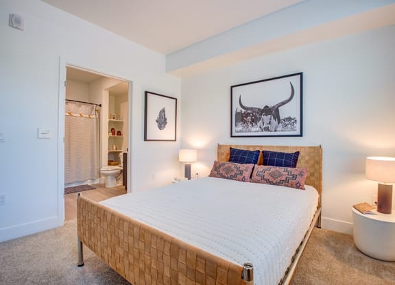 a bedroom with a large bed and a bathroom in the background at 38° NORTH, Santa Rosa