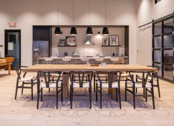 a large wooden table with chairs and a kitchen in the background at 38° NORTH, Santa Rosa, 95404