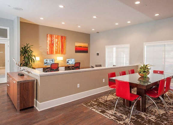 A dining room with a table set for four.