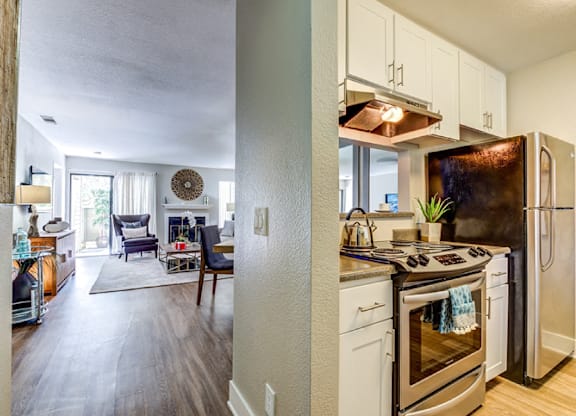 A kitchen with a stove and refrigerator in it.
