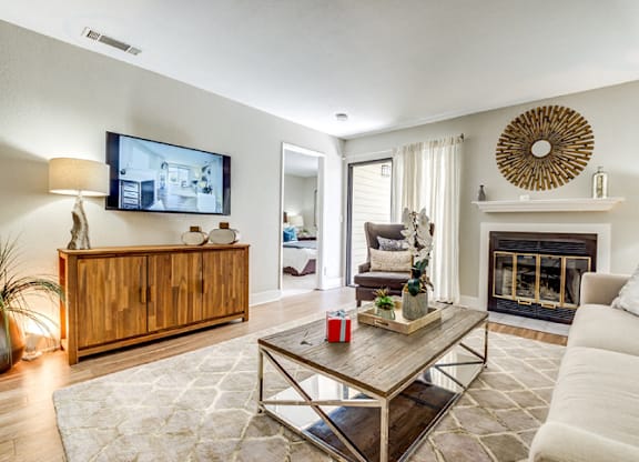A modern living room with a fireplace and a flat screen TV.