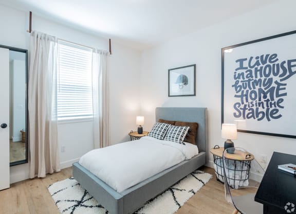 Bedroom with Wood-Style Flooring, a Window, and Stylish Decor at Crocker Village – Single Family Homes, Sacramento California ? 
