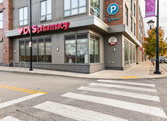 A CVS Pharmacy is located on the corner of a street at Trio Newton Apartments, Massachusetts