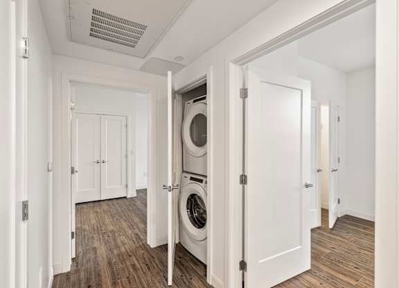 A laundry room with a washer and dryer in it. at Trio Newton Apartments, Newton, MA, 02460