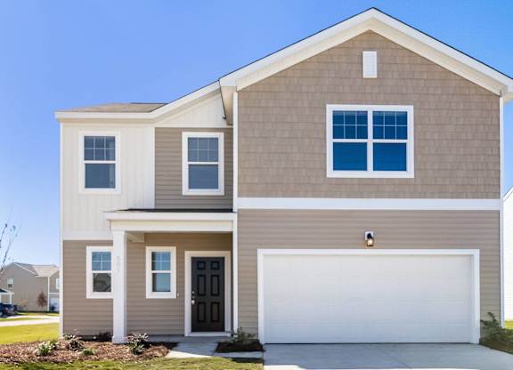 a tan house with a white garage door