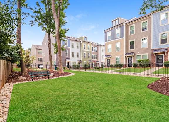A grassy area in front of apartment buildings.