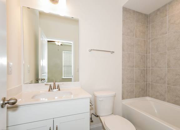 Charlotte NC Luxury Apartments for Rent - Loso Walk - Bathroom With Vinyl Plank Flooring, Vanity Sink, Toilet, And Shower With Tub Combo.