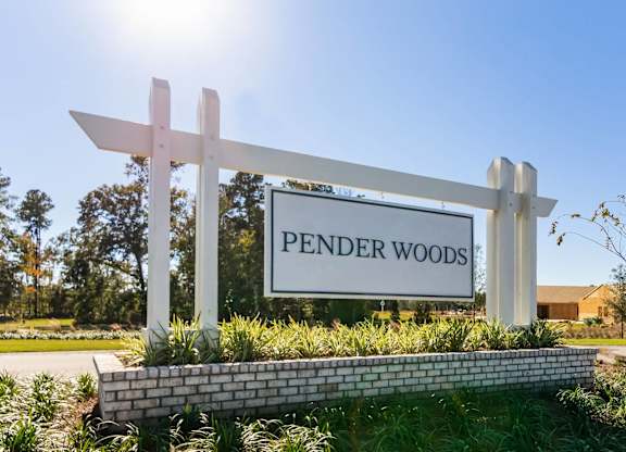 a sign that reads pender woods in front of a building