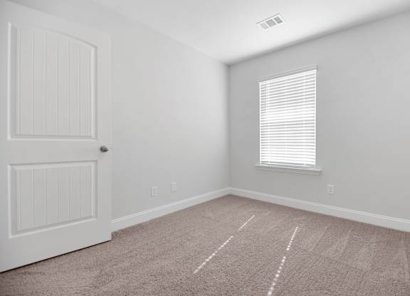 Cottonvale Towns in Savannah, GA photo of guest bedroom with plus carpeting and a window