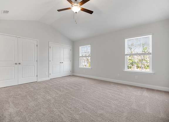 Cottonvale Towns in Savannah, GA photo of bedroom with plush carpeting and ceiling fan