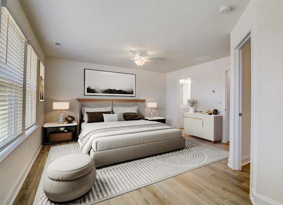 A bedroom with a large bed and a painting above it.