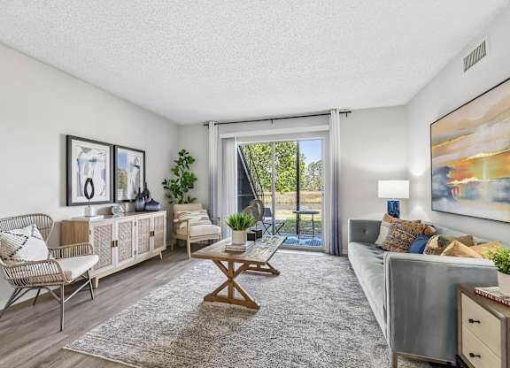 A living room with a sofa, chair, and a table.