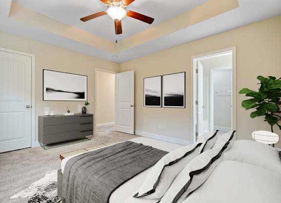 Omnia at Richmond Hill Townhomes in Georgia photo of a bedroom with a bed and a ceiling fan.