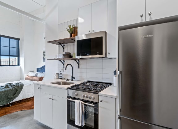 a kitchen with stainless steel appliances and a stainless steel refrigerator