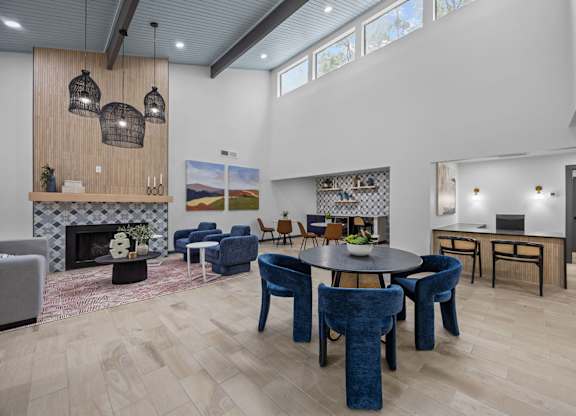 A modern living room with a fireplace and a dining table.