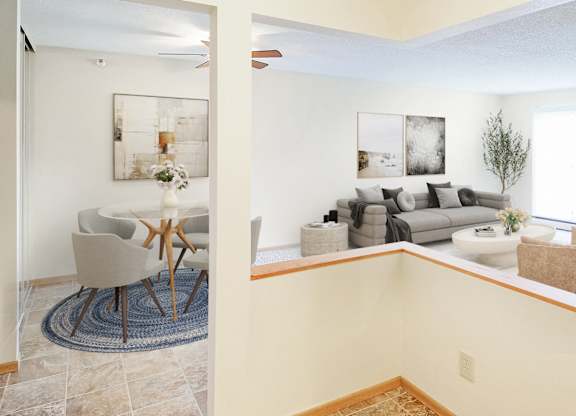 A living room with a couch, chair, and a painting on the wall.