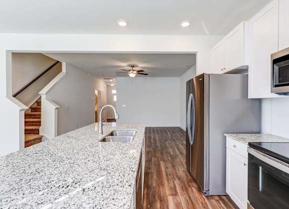 a kitchen with granite counter tops and stainless steel appliances