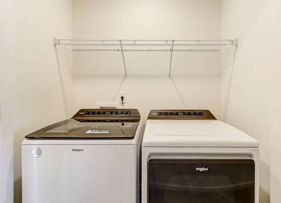 a laundry room with two washes and a dryer