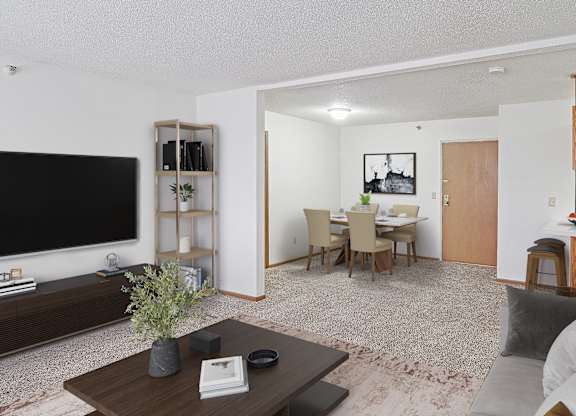 A living room with a grey couch and a wooden coffee table.