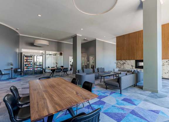 A modern dining area with a wooden table surrounded by chairs.