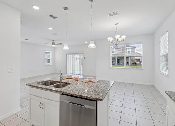 A kitchen with granite countertops and stainless steel appliances.